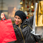 cheerful-woman-with-shopping-bags-city 1