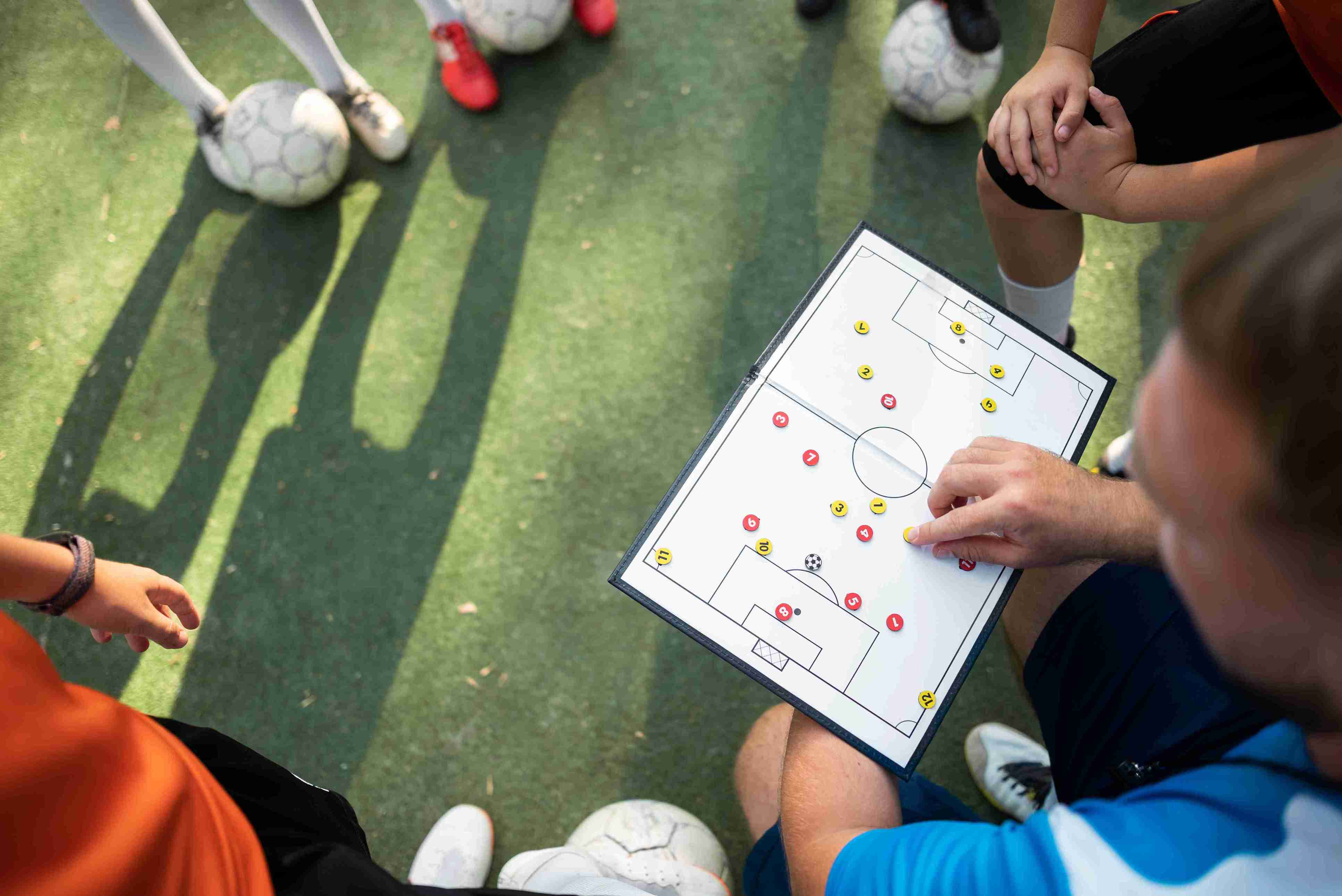 football-trainer-teaching-his-pupils_11zon