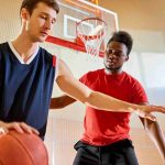 professional-basketball-player-dribbling-near-competitors-basket_11zon
