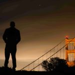 silhouette-man-standing-against-golden-gate-bridge-night_11zon