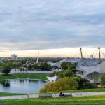 wide-angle-shot-city-full-greenery-trees-sky-full-clouds_11zon