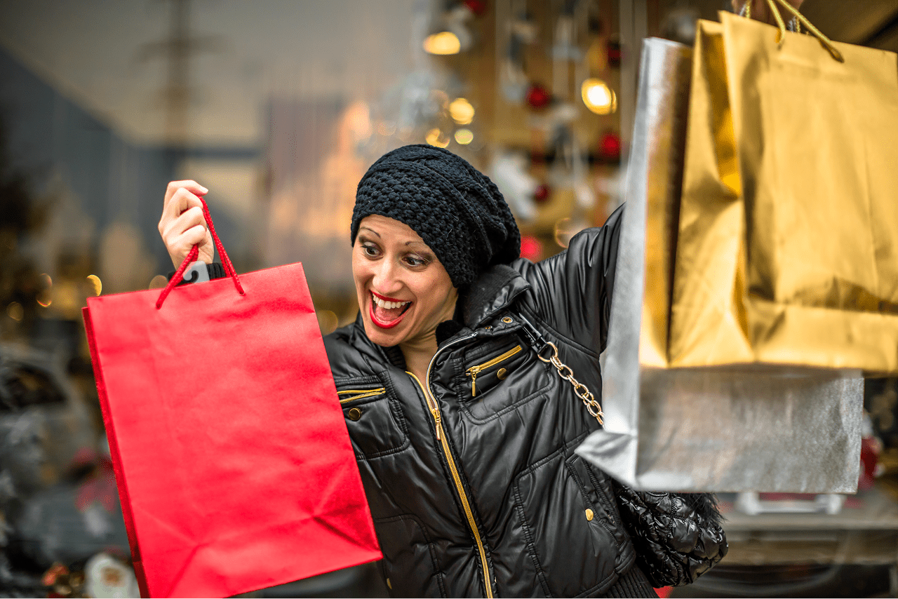 cheerful-woman-with-shopping-bags-city 1