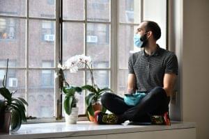 full-length-man-sitting-by-window-home