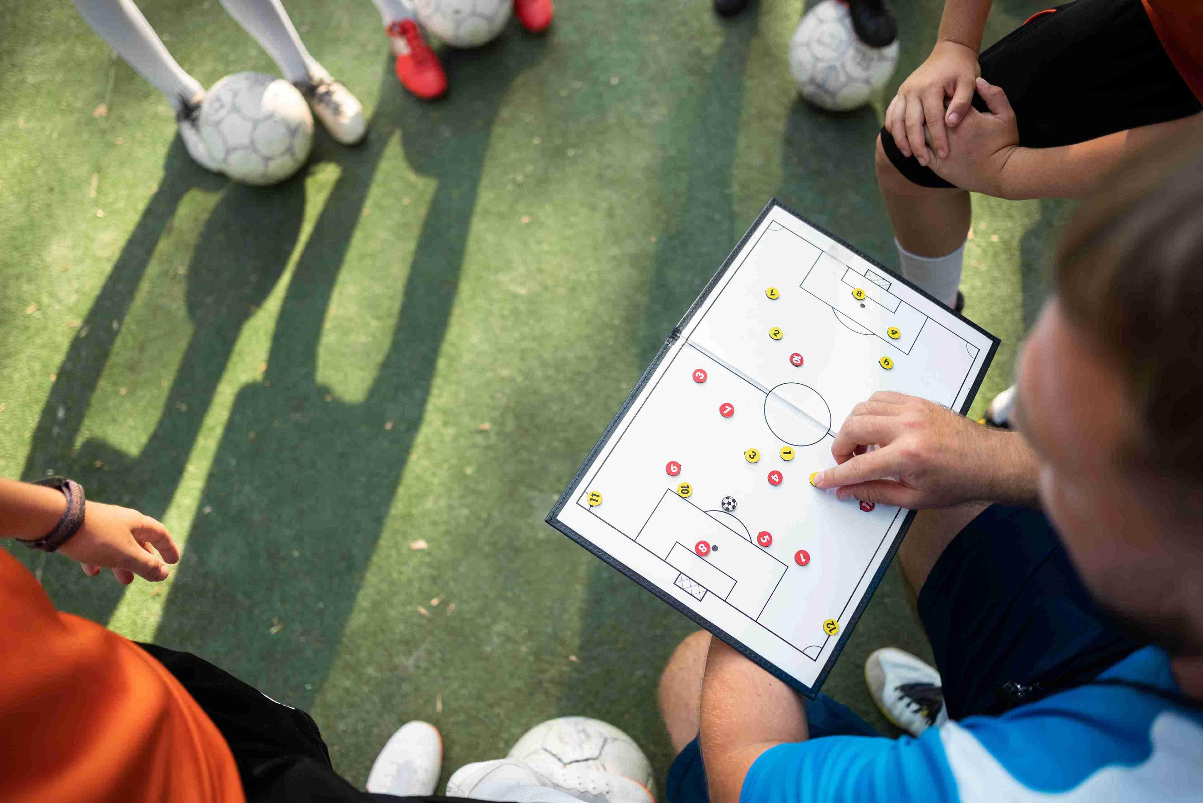 football-trainer-teaching-his-pupils_11zon