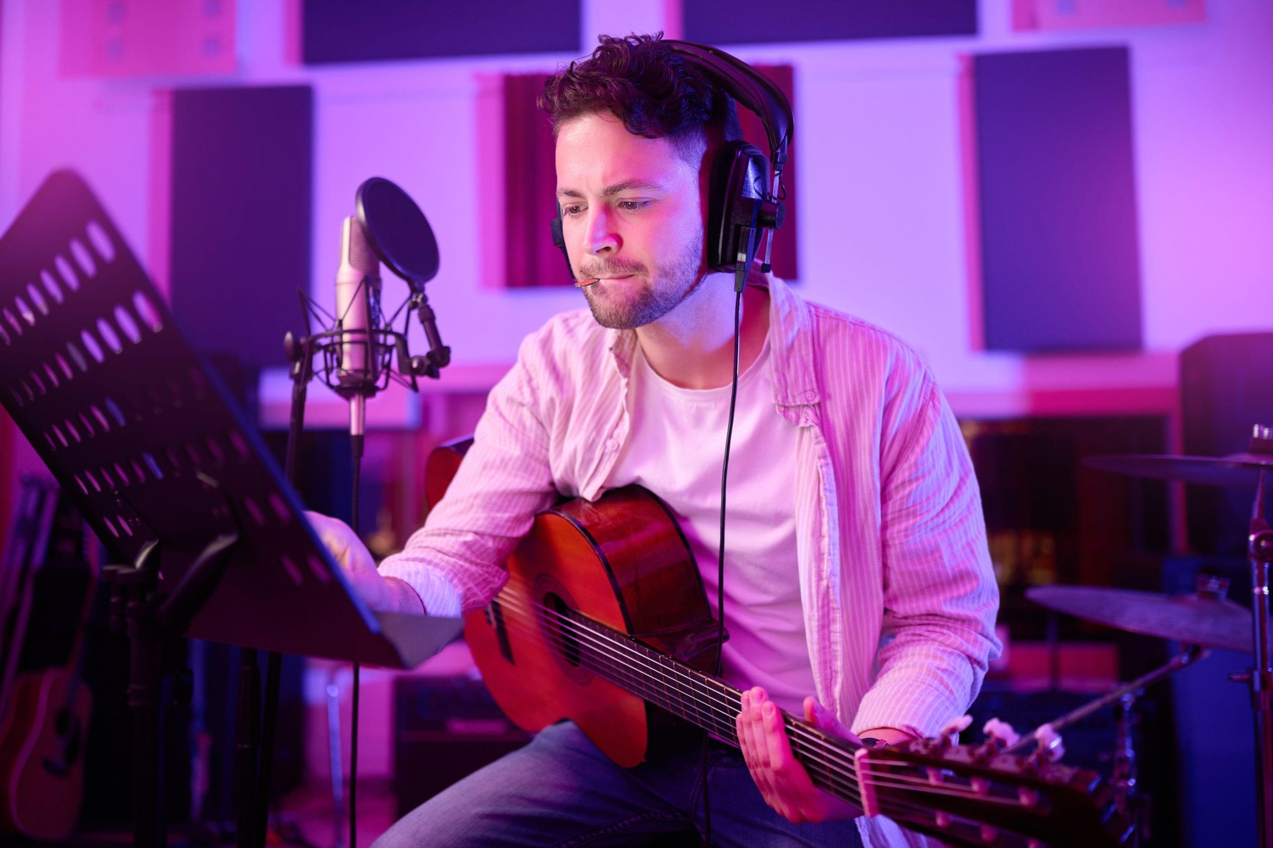 man-headphones-guitar-neon-studio-recording-production-performance-radio-mic-label-band-concert-guitarist-artist-thinking-musician-strings-instrument-night-light-practice