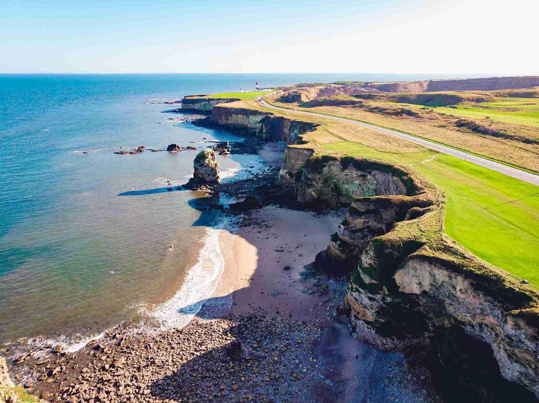 aerial-shot-clear-blue-sea-grassy-shore_11zon